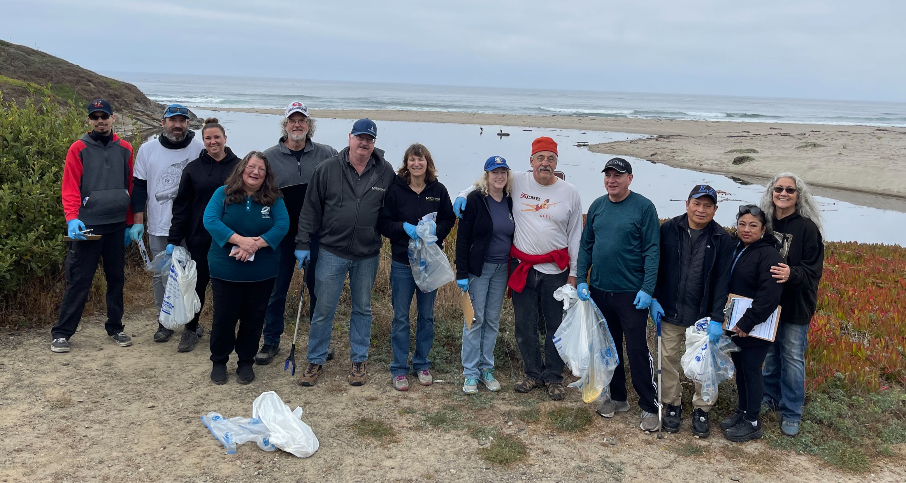 North Coast Introduces Shamrock Red 12 Group photo of North Coast Brewing employees on a beach cleanup day.