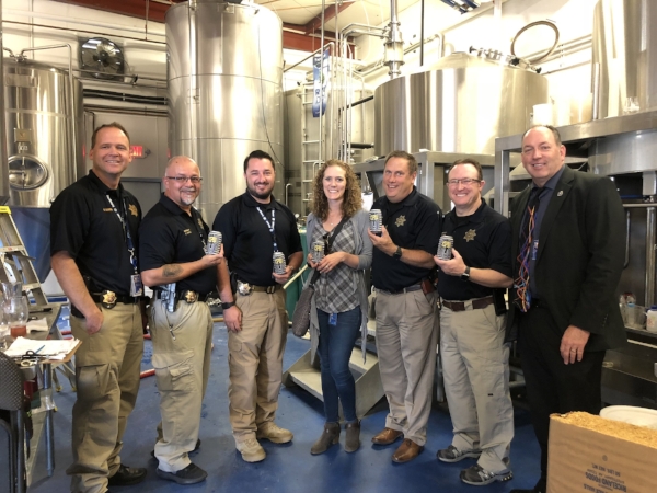 Rockyard Canning 2018 Blue Ale for ZPIII Memorial Softball Tournament 8 Representatives from the Douglas County Sheriff's Office during canning day.