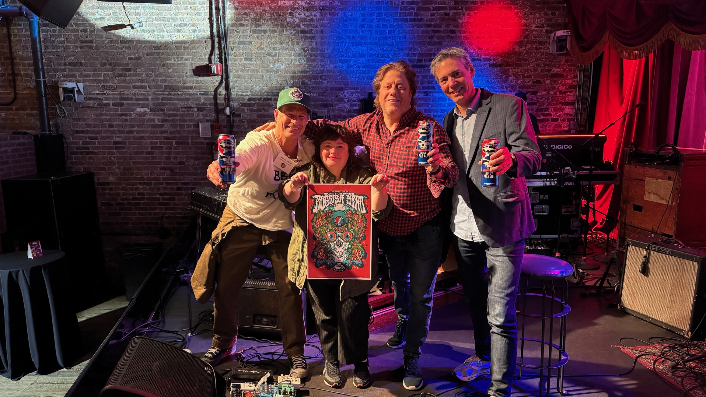 Dogfish Head: The return of our partnership with the Grateful Dead calls for a chart-topping Record Store Day! 8 Sam from Dogfish Head, David from the Grateful Dead, Carrie from Record Store Day and Pete from Brooklyn Bowl all standing on a stage holding up the 2025 Record Store Day poster