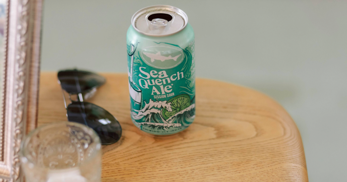 Dogfish Head Weddings - Love is INN the Air 25 a can of seaquench next to a pair of sunglasses on a table