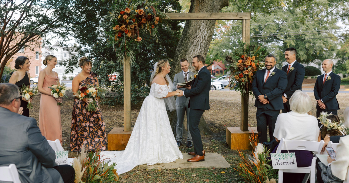Dogfish Head Weddings - Love is INN the Air 31 a bride and groom outside under a wedding arbor