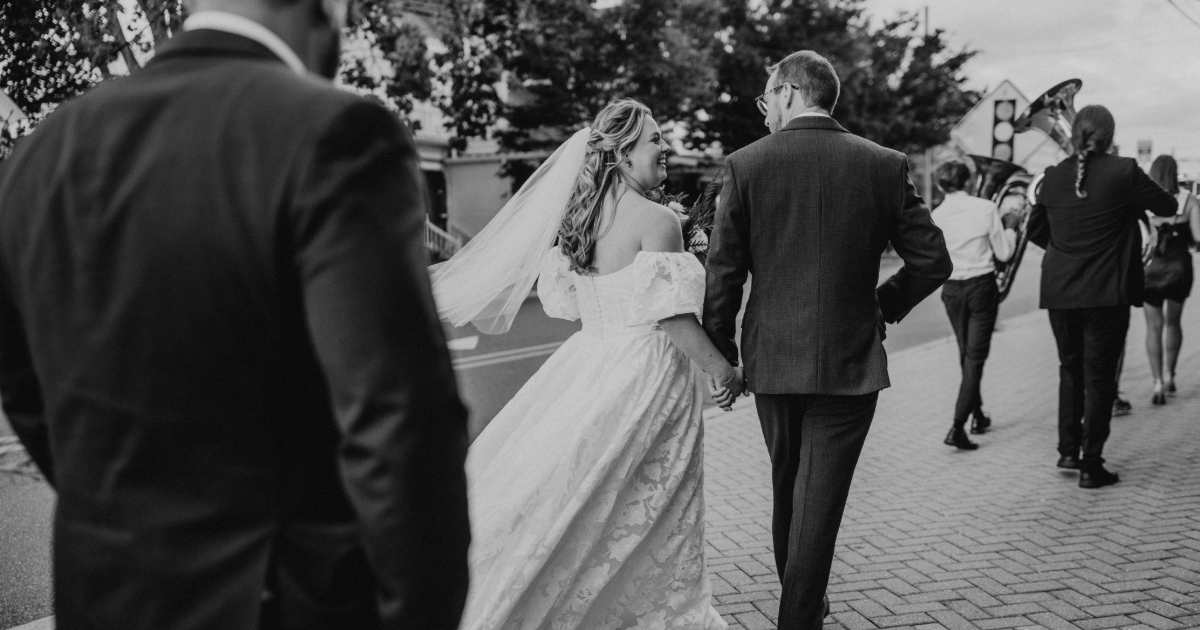 Dogfish Head Weddings - Love is INN the Air 32 bride and groom walking down street