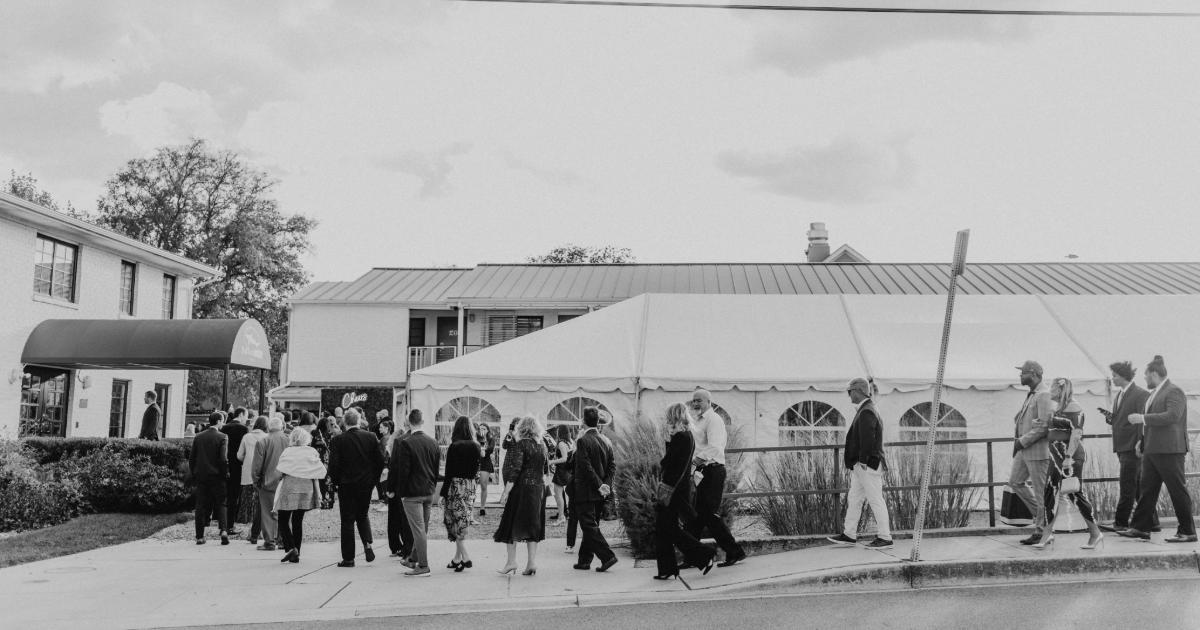 Dogfish Head Weddings - Love is INN the Air 33 group of wedding guests walking down the street in front of the dogfish inn
