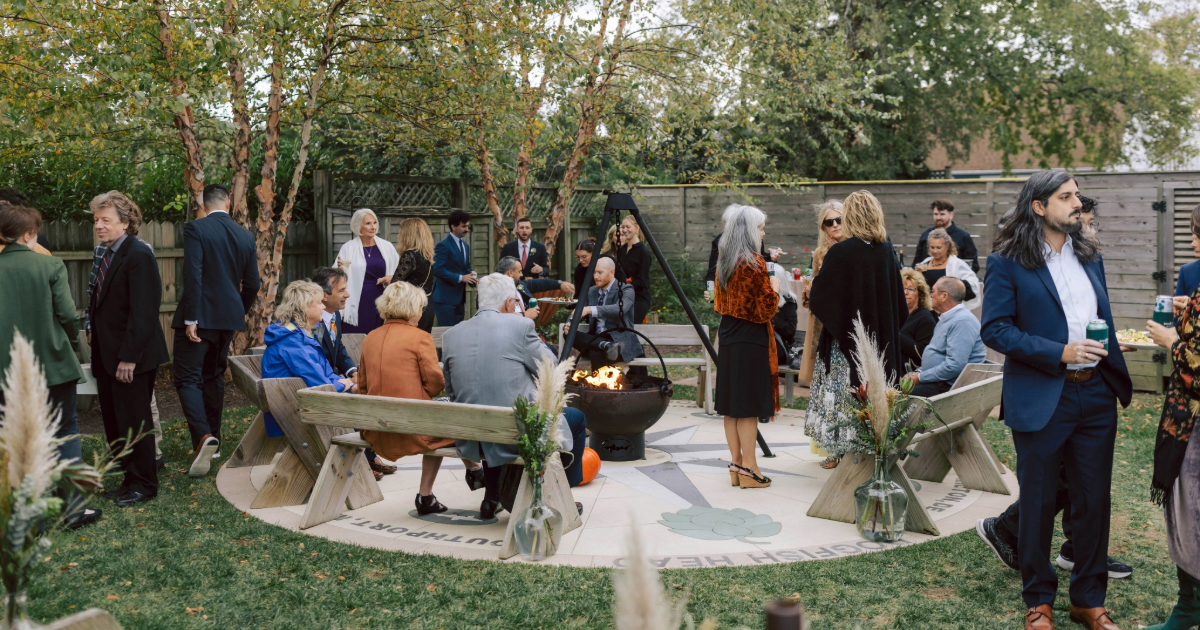 Dogfish Head Weddings - Love is INN the Air 34 wedding guests around the dogfish inn firepit