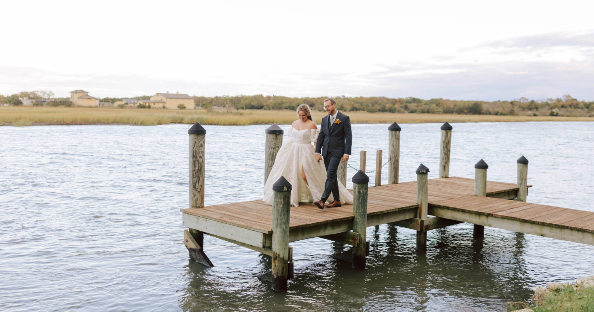 Dogfish Head Weddings - Love is INN the Air 35 bride and groom on a pier