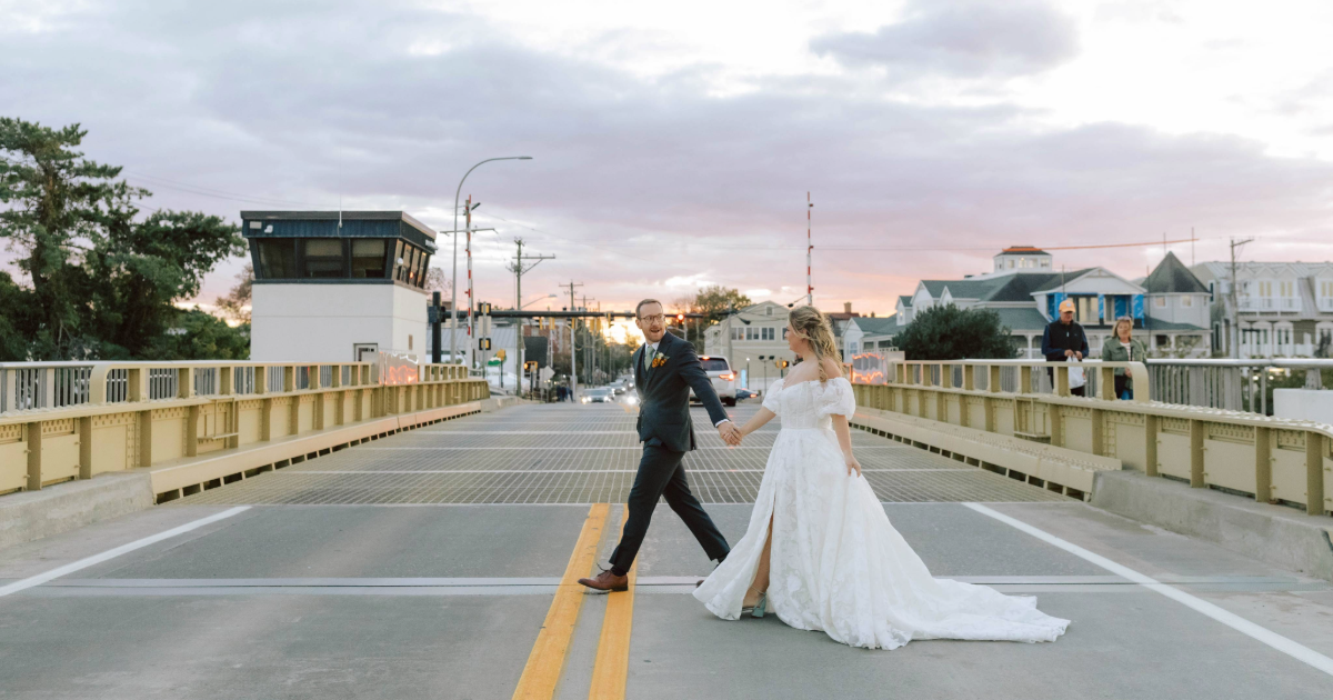 Dogfish Head Weddings - Love is INN the Air 36 bride and groom on a bridge at sunset