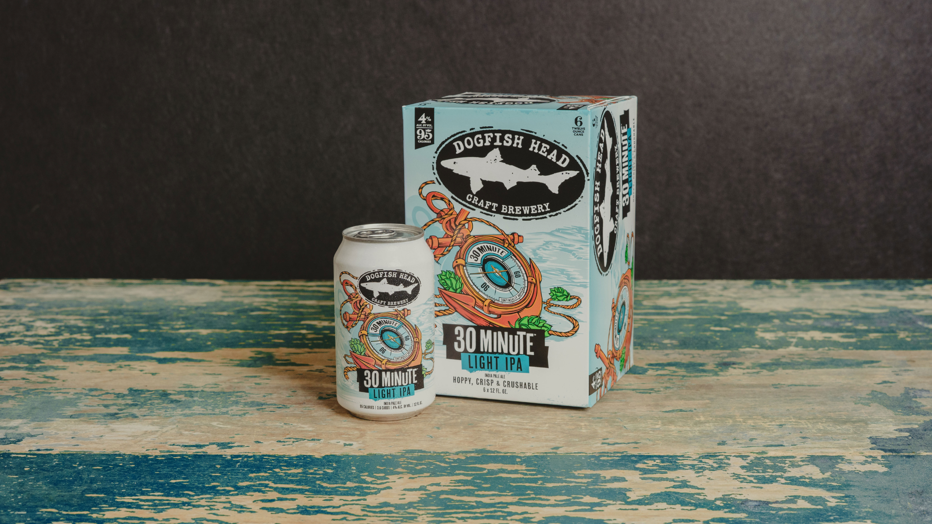 Dogfish Head: Lighten up … it's only Quitter's Day! 11 Dogfish Head 30 Minute Light IPA 12 oz can and 6-pack on top of a counter with a brewery behind it