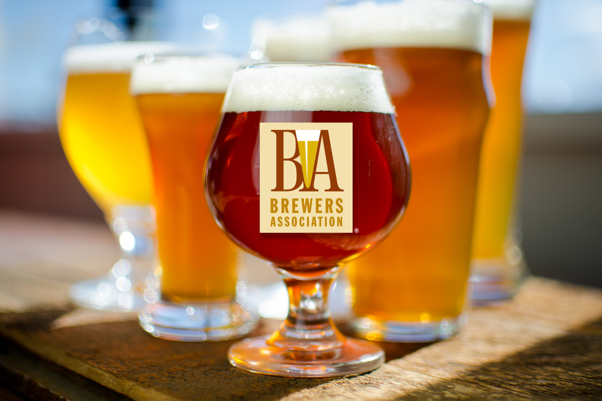 Brewers Association Releases 2024 Beer Style Guidelines 8 Various glasses of colorful beer on a sunny table, with a BA logo in the center of one.