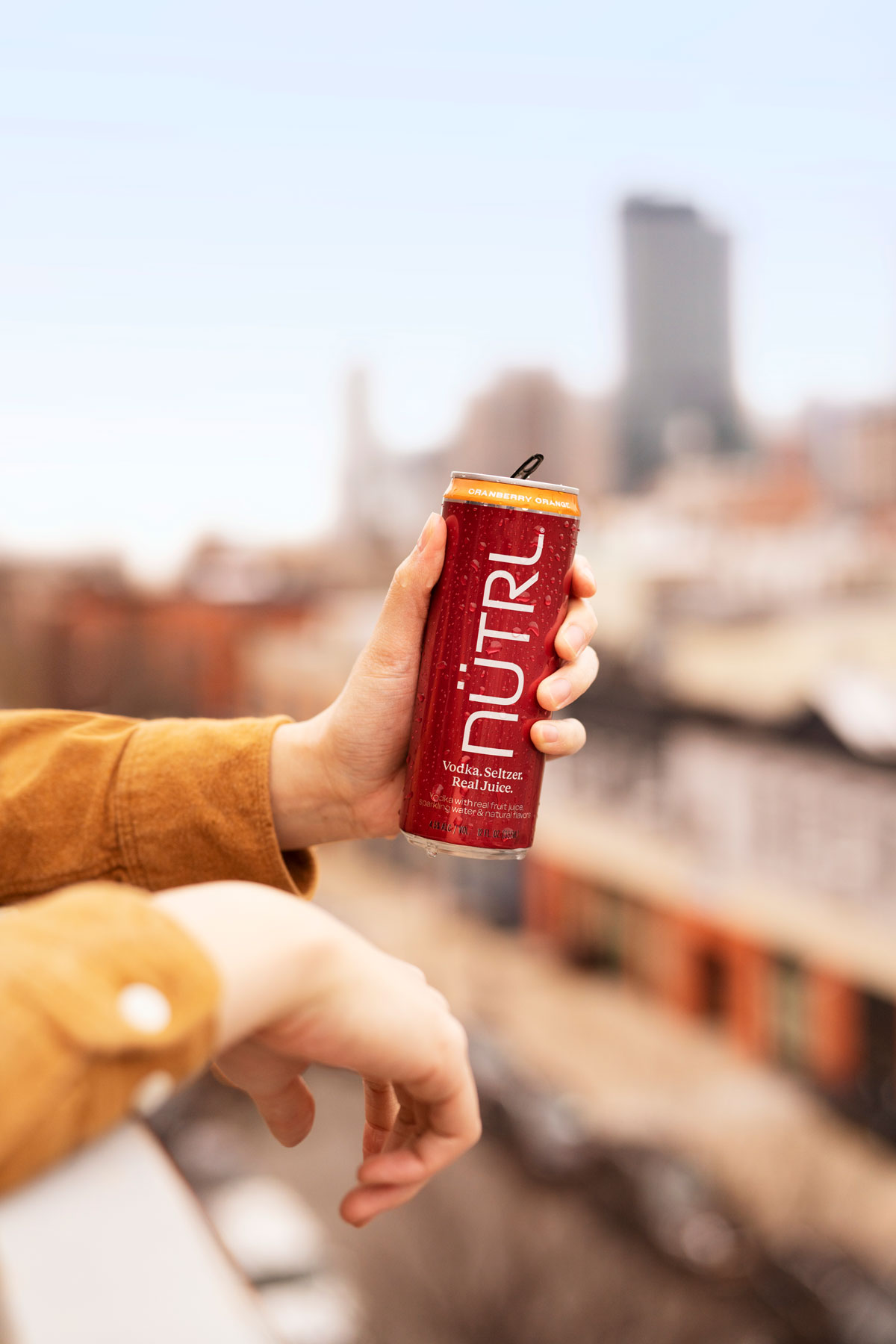 Anheuser-Busch’s NÜTRL Relaunches Nationwide Fan-Favorite Cranberry Variety Pack Made with Simple Ingredients: Real Vodka, Seltzer and Real Juice. 10 hand holding nutrl can