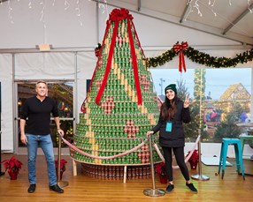 Dogfish Head's Beer & Benevolence Program Makes an Impactful Splash in 2022 20 Coworkers in front of can-donation Christmas tree