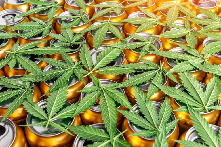 Hemp-infused seltzer cans with cannabis leaves