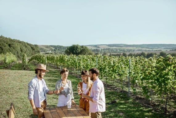 Good friends having a tasting event in a scenic vineyard