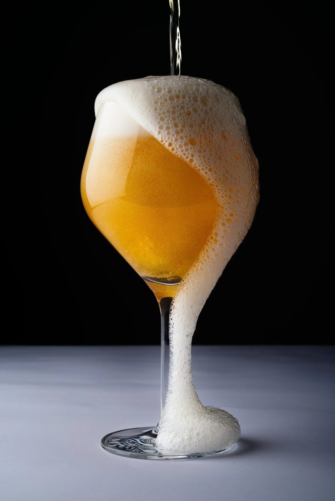 A beermosa cocktail with wine overflowing out of the glass