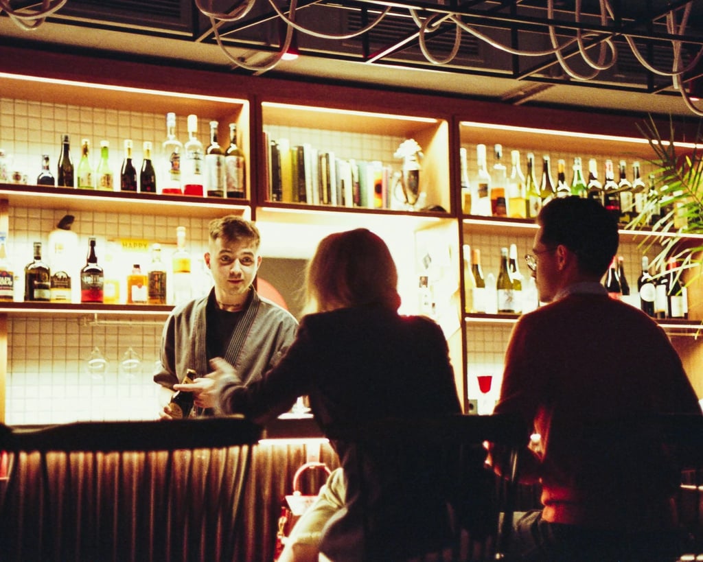 Two people placing an order at a bar