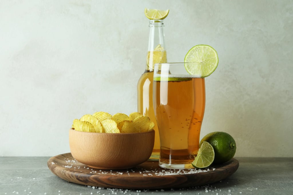 A glass of chelada (beer with lime and salt) served with snacks.