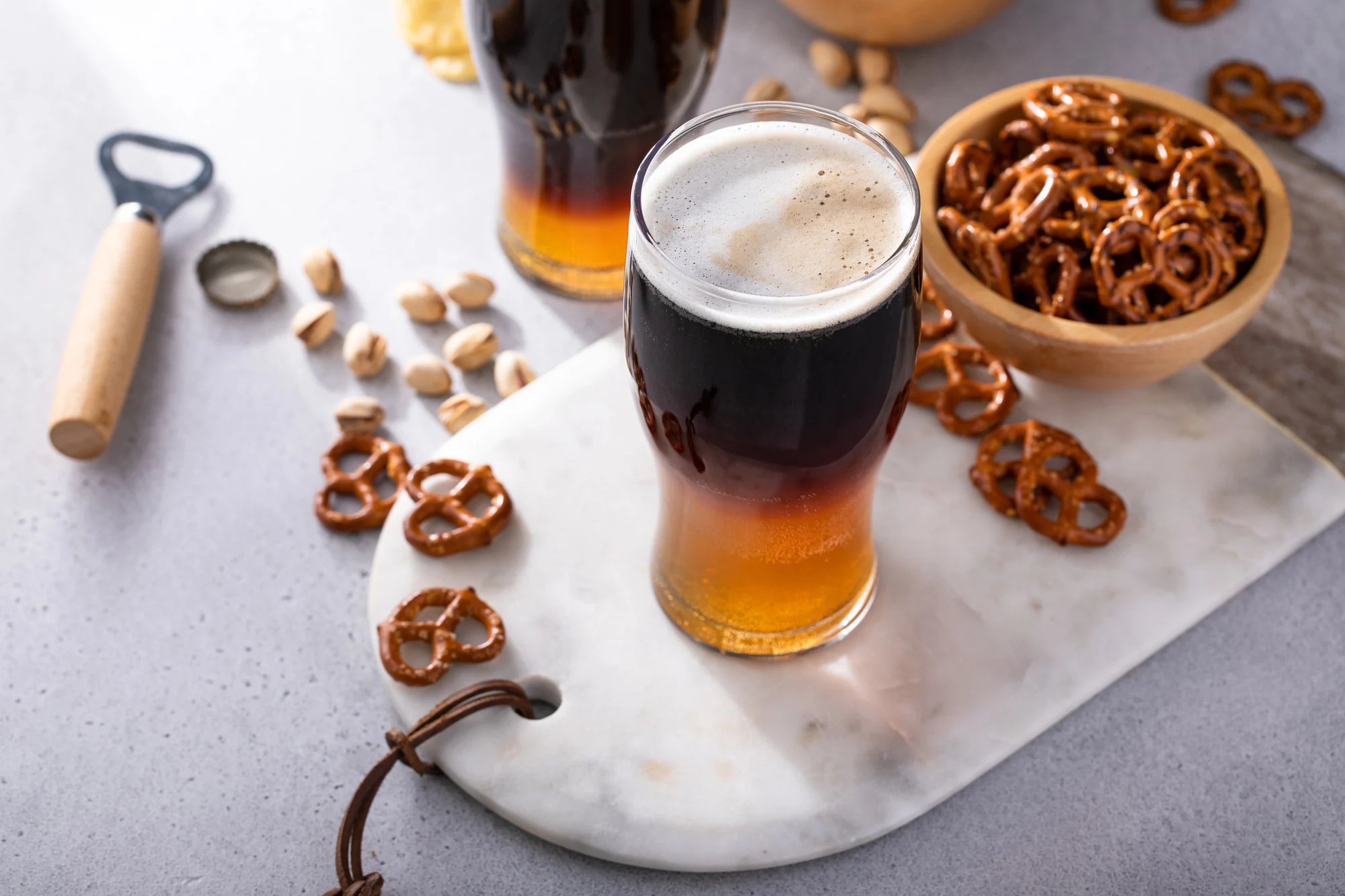 Black and tan cocktail with pale ale and dark stout beer.