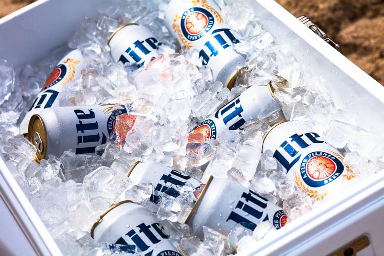 A cooler full of domestic beer cans of Miller Lite on ice