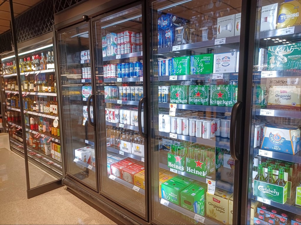 What Are Domestic Beers? Popular American Brands Explained 8 A package store refrigerator showcasing domestic beer selections